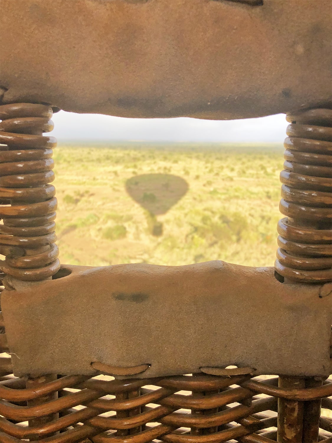 Image of the shadow of the balloon seen from the hot air balloon of a balloon safari by Kilimanjaro Balloon Safaris
