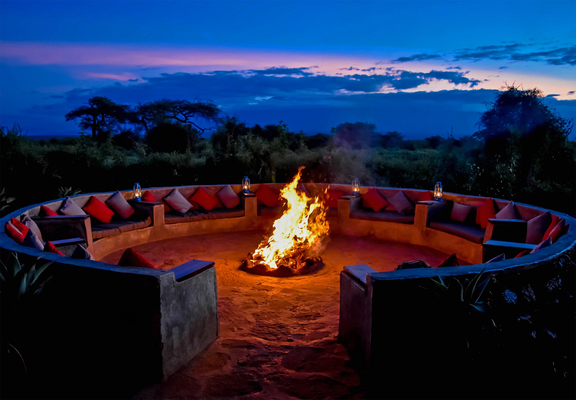 Image of the seating around the campfire while the sun is setting at Tulia Amboseli Safari Camp
