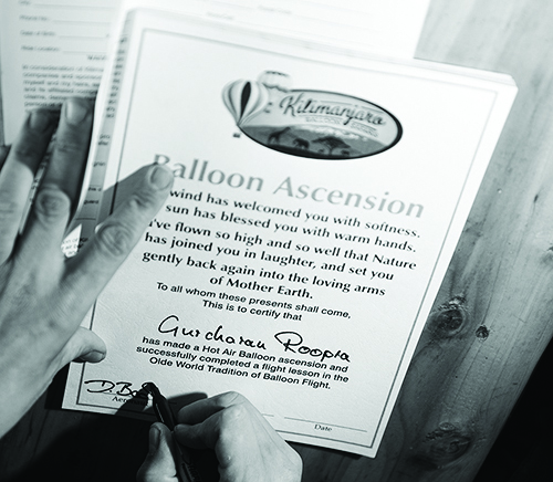 Image of the Balloon Ascension certificate being signed by the Kilimanjaro Balloon Safari team at Amboseli National Park, Kenya